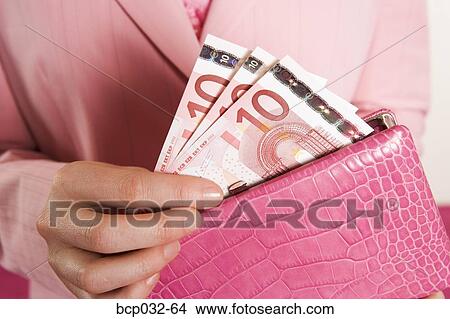 Woman removing euro banknotes from purse View Large Photo Image Picture - Woman removing euro banknotes from purse. Fotosearch
