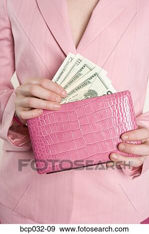 Woman taking American currency out of purse View Large Photo Image Stock Photo - Woman taking American currency out of purse. Fotosearch