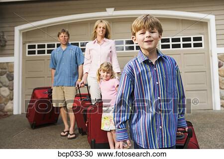 Family pulling luggage View Large Photo Image Stock Image - Family pulling luggage. Fotosearch