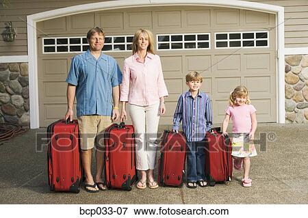 Family standing together with luggage View Large Photo Image Stock Photo - Family standing together with luggage. Fotosearch
