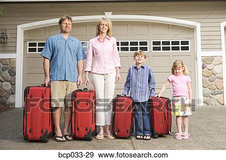 Family standing together with luggage View Large Photo Image Stock Photo - Family standing together with luggage. Fotosearch