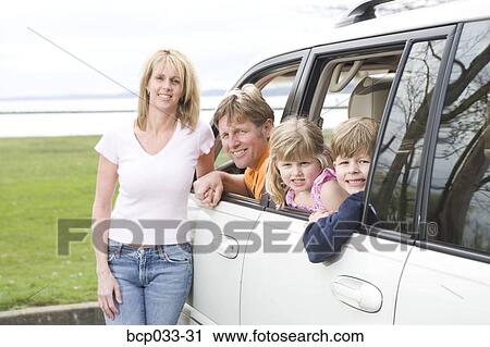 Stock Image - Happy family together in minivan. Fotosearch
