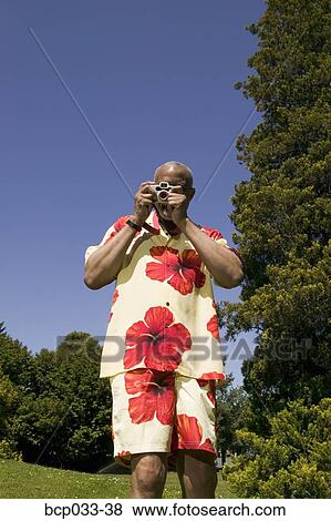 Man with camera taking picture View Large Photo Image Stock Photo - Man with camera taking picture. Fotosearch