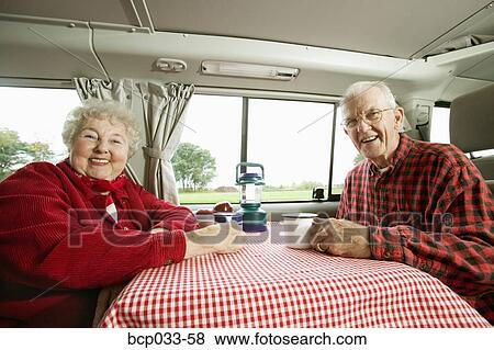 Senior couple sitting together in their van View Large Photo Image Stock Photo - Senior couple sitting together in their van. Fotosearch