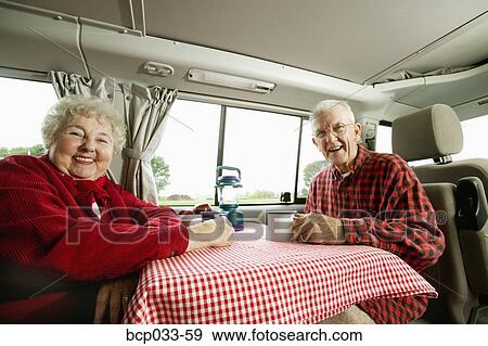 Senior couple sitting together in their van View Large Photo Image Stock Photo - Senior couple sitting together in their van. Fotosearch