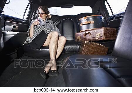 Woman and luggage in limousine View Large Photo Image Picture - Woman and luggage in limousine. Fotosearch