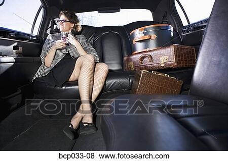 Woman and luggage in limousine View Large Photo Image Stock Photo - Woman and luggage in limousine. Fotosearch