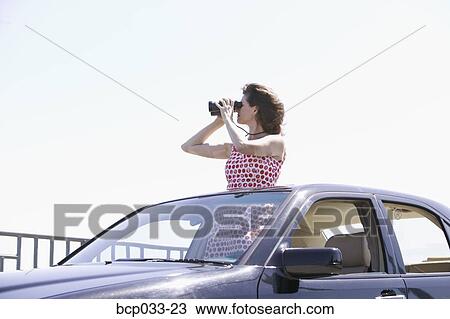 Woman looking through binoculars View Large Photo Image Stock Image - Woman looking through binoculars. Fotosearch