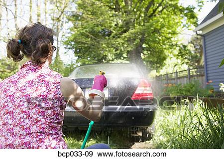 Woman washing car View Large Photo Image Stock Photo - Woman washing car. Fotosearch