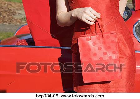 Closeup of woman holding shopping bag View Large Photo Image Stock Photography - Closeup of woman holding shopping bag. Fotosearch