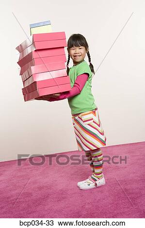 Girl holding many boxes View Large Photo Image Stock Image - Girl holding many boxes. Fotosearch