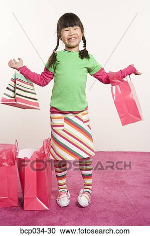 Girl holding shopping bags View Large Photo Image Stock Image - Girl holding shopping bags. Fotosearch