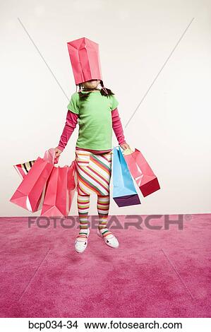Jumping girl with shopping bags View Large Photo Image Picture - Jumping girl with shopping bags. Fotosearch