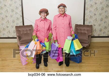 Senior women holding many shopping bags View Large Photo Image Stock Photograph - Senior women holding many shopping bags. Fotosearch