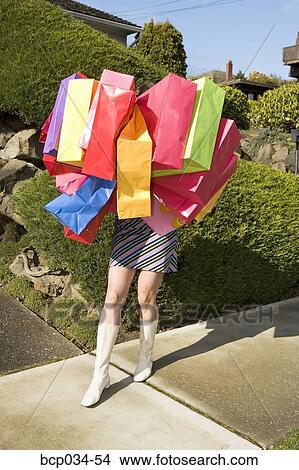 Woman carrying many shopping bags View Large Photo Image Picture - Woman carrying many shopping bags. Fotosearch