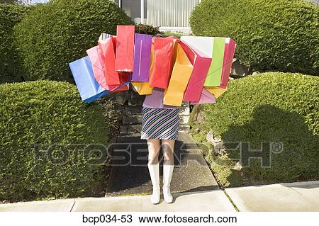 Woman carrying many shopping bags View Large Photo Image Stock Image - Woman carrying many shopping bags. Fotosearch