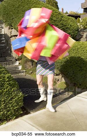 Woman carrying many shopping bags View Large Photo Image Stock Photography - Woman carrying many shopping bags. Fotosearch