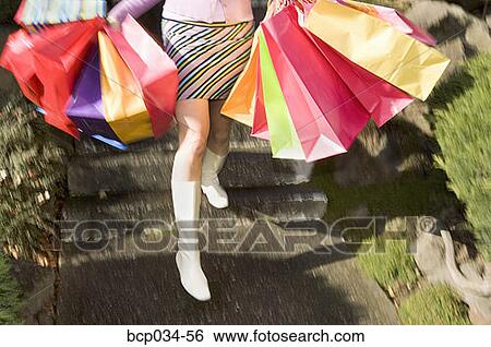 Woman carrying several shopping bags View Large Photo Image Stock Photograph - Woman carrying several shopping bags. Fotosearch