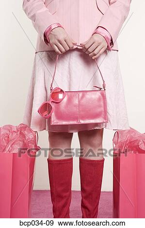 Woman standing beside shopping bags View Large Photo Image Stock Photo - Woman standing beside shopping bags. Fotosearch