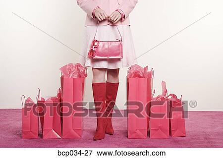 Woman standing with shopping bags View Large Photo Image Stock Photo - Woman standing with shopping bags. Fotosearch