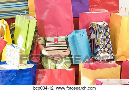 Woman surrounded by shopping bags View Large Photo Image Stock Image - Woman surrounded by shopping bags. Fotosearch