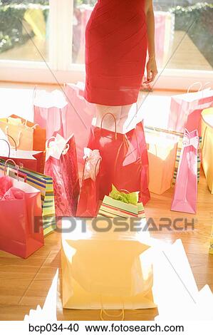 Woman surrounded by shopping bags View Large Photo Image Stock Image - Woman surrounded by shopping bags. Fotosearch