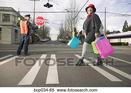 Woman with shopping bags crossing street View Large Photo Image Stock Photography - Woman with shopping bags crossing street. Fotosearch