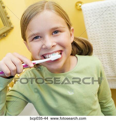 Girl brushing teeth View Large Photo Image Picture - Girl brushing teeth. Fotosearch
