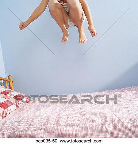 Girl jumping on bed View Large Photo Image Stock Image - Girl jumping on bed. Fotosearch