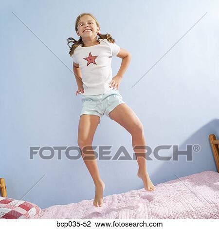 Girl jumping on bed View Large Photo Image Stock Image - Girl jumping on bed. Fotosearch