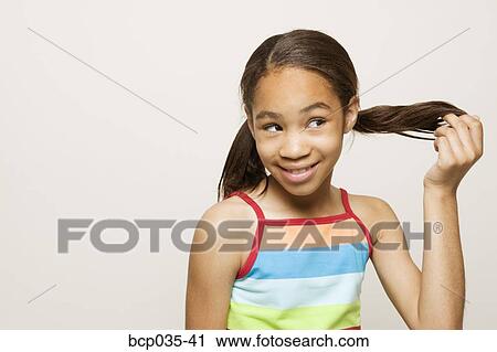 Girl playing with hair View Large Photo Image Stock Image - Girl playing with hair. Fotosearch