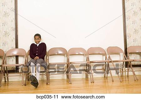 Stock Image - Girl sitting alone. Fotosearch