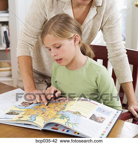 Girl studying map in book View Large Photo Image Stock Image - Girl studying map in book. Fotosearch