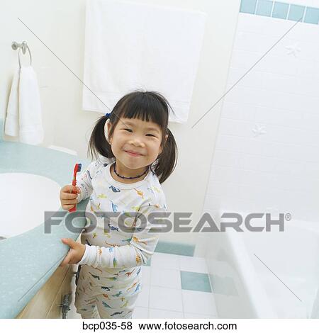 Girl with toothbrush wearing pajamas View Large Photo Image Stock Photo - Girl with toothbrush wearing pajamas. Fotosearch