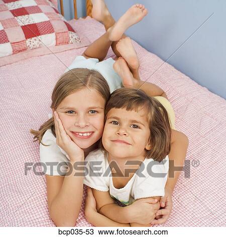 Girls together on bed View Large Photo Image Stock Image - Girls together on bed. Fotosearch