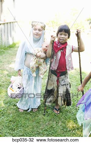 Stock Image - Girls wearing costumes. Fotosearch