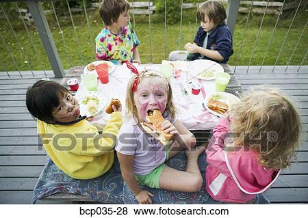 Group of children eating outside View Large Photo Image Stock Photo - Group of children eating outside. Fotosearch