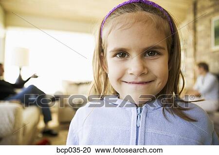 Stock Image - Portrait of girl smiling at camera. Fotosearch