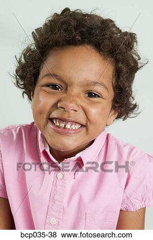 Stock Photo - Portrait of girl smiling at camera. Fotosearch
