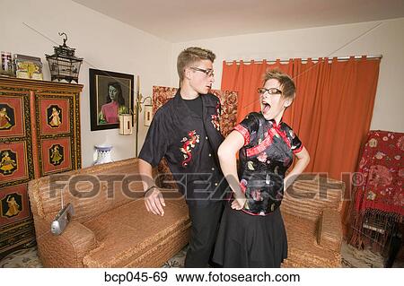 Couple in Asian clothing dancing at home View Large Photo Image Stock Photo - Couple in Asian clothing dancing at home. Fotosearch
