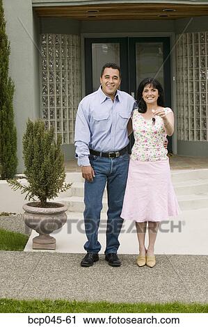 Couple with keys to new home View Large Photo Image Stock Image - Couple with keys to new home. Fotosearch