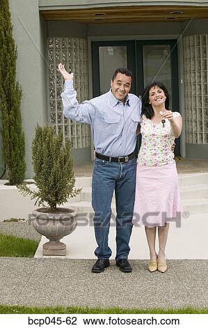 Stock Image - Couple with keys to new home. Fotosearch