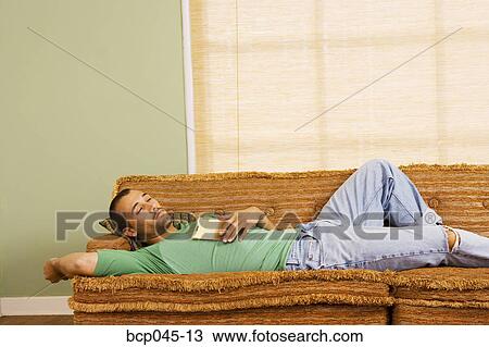 Man asleep on sofa View Large Photo Image Stock Image - Man asleep on sofa. Fotosearch