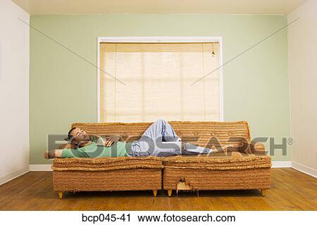 Man asleep on sofa View Large Photo Image Stock Image - Man asleep on sofa. Fotosearch