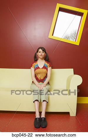 Portrait of girl sitting on sofa View Large Photo Image Stock Image - Portrait of girl sitting on sofa. Fotosearch