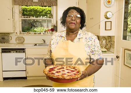 Portrait of woman holding homemade pie View Large Photo Image Stock Photo - Portrait of woman holding homemade pie. Fotosearch