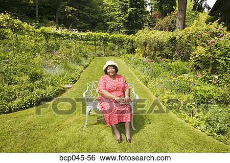 Portrait of woman sitting in park View Large Photo Image Stock Photograph - Portrait of woman sitting in park. Fotosearch