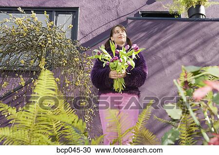 Woman holding bouquet of tulips View Large Photo Image Stock Image - Woman holding bouquet of tulips. Fotosearch