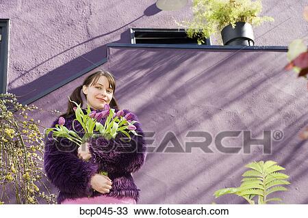 Woman holding bouquet of tulips View Large Photo Image Stock Image - Woman holding bouquet of tulips. Fotosearch