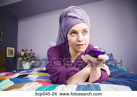 Woman holding remote control View Large Photo Image Picture - Woman holding remote control. Fotosearch